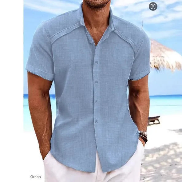 Man wearing a solid colour Hawaiian casual short sleeve shirt in a cotton blend fabric.