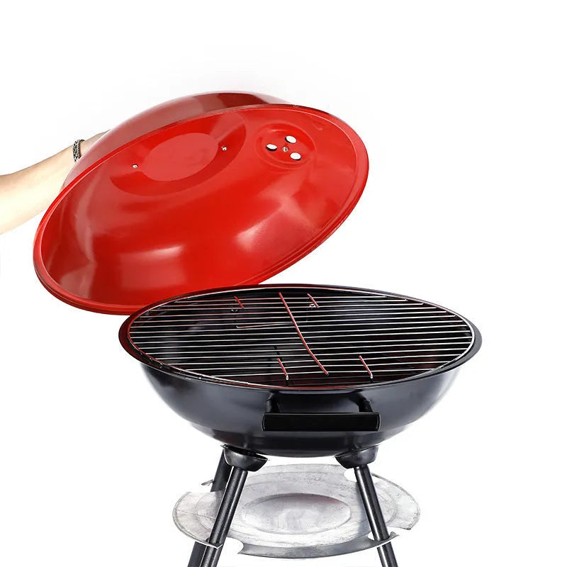 Portable round iron barbecue grill with 14-inch cooking grate, shown on a patio.