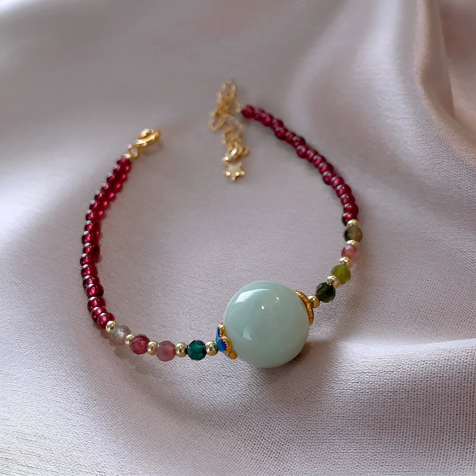 Aquamarine garnet bracelet with drop-shaped tourmaline centrepiece on wrist