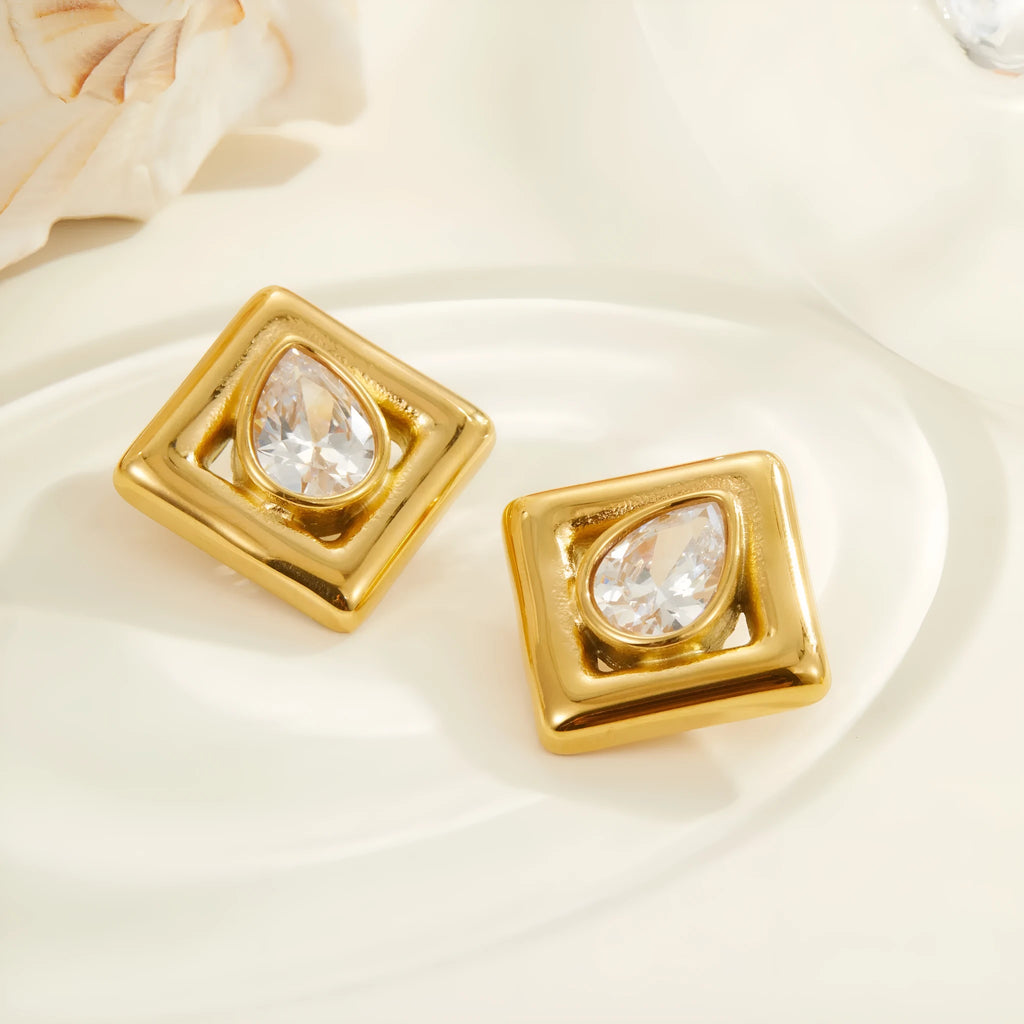 A pair of gold-coloured geometric stud earrings featuring an inlaid water drop zircon stone.