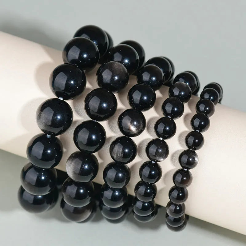 Hand-woven obsidian couples bracelet with year of birth engraving and multiple bead diameter options