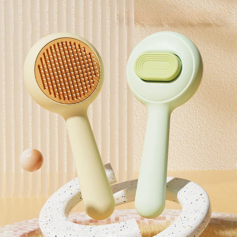 Green cat grooming brush with stainless steel pins and non-slip handle for pet hair removal