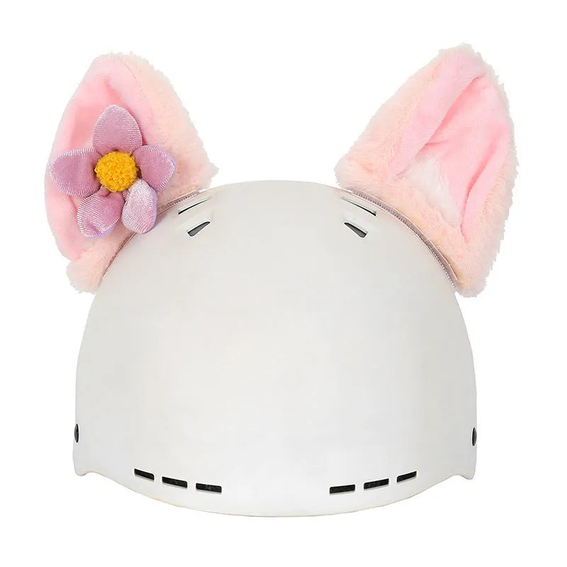 Colourful plush cartoon hat decoration sitting on top of a ski helmet