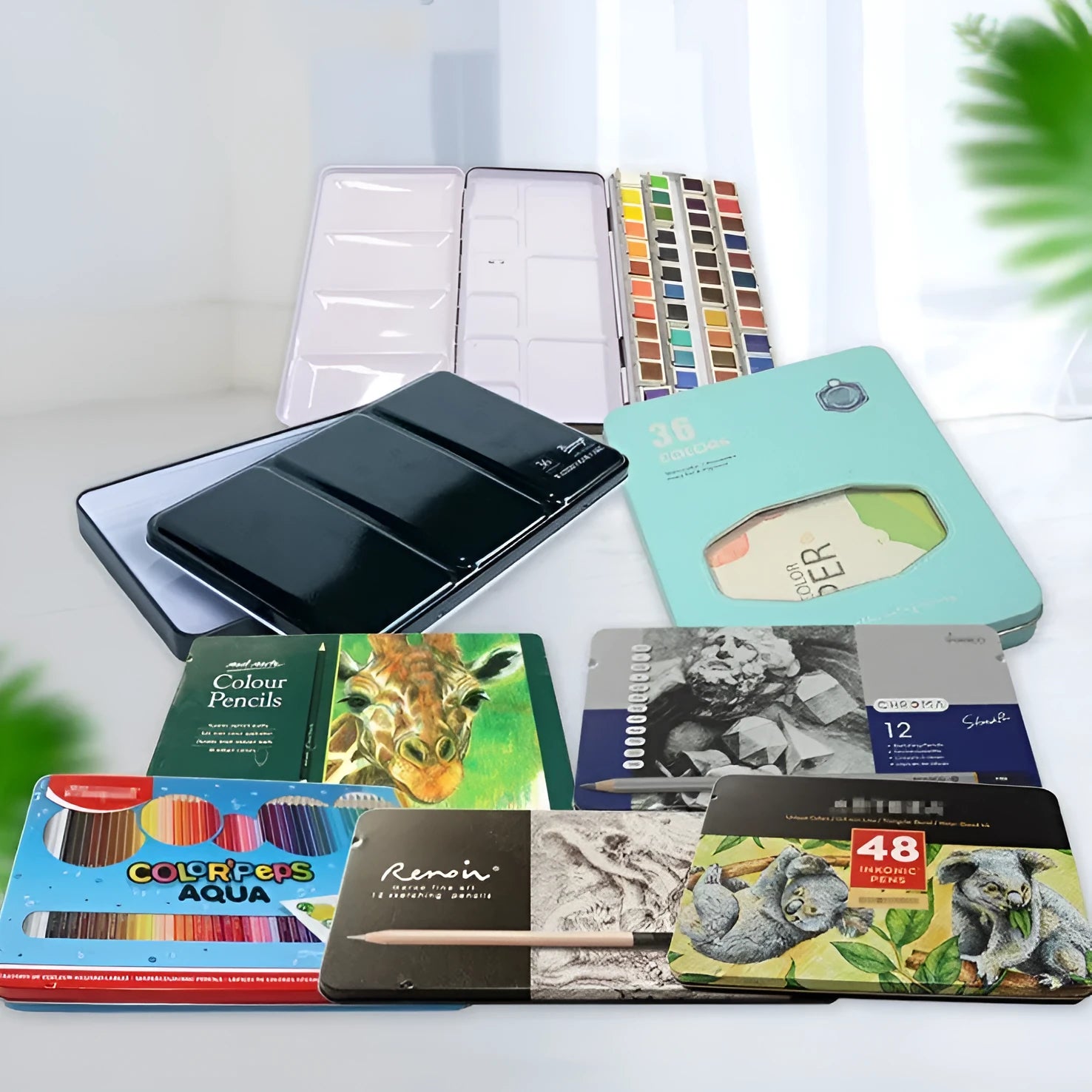 Square tinplate metal paint box for solid watercolours with folding compartment design.