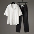 Men's grey Chinese-style casual two-piece sportswear set with short sleeve top and trousers on a hanger.