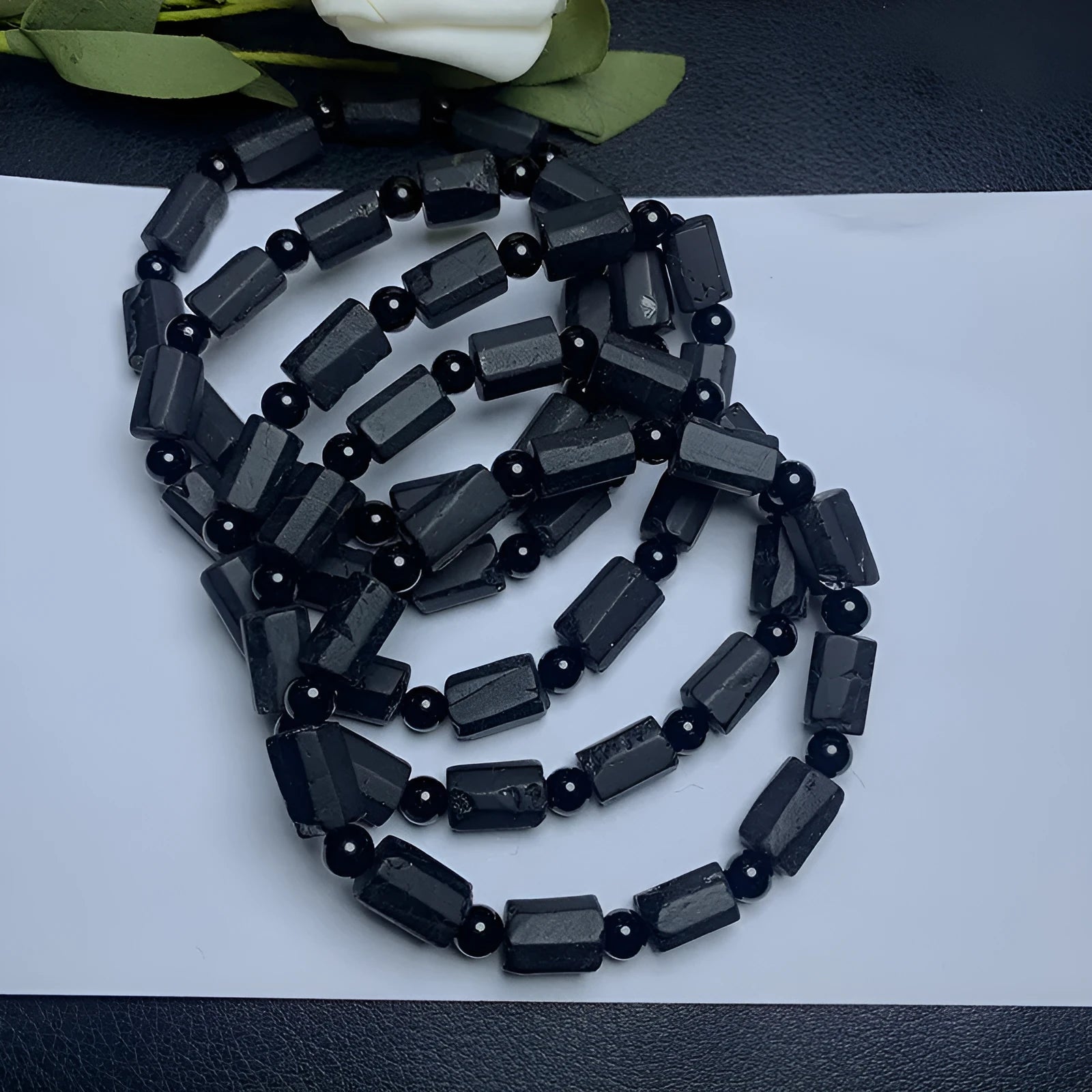 Natural black tourmaline rough stone bracelet with polished beads on wrist