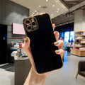 Luxury solid colour electroplated mobile phone case for iPhone 13 series on a table.