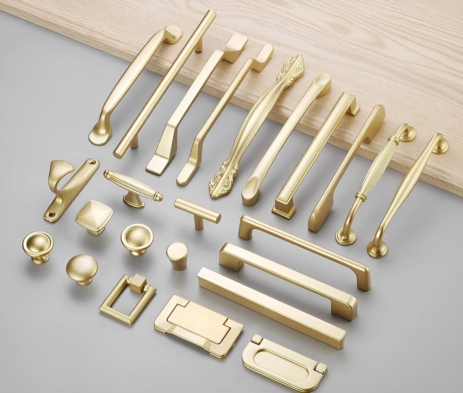 Brushed gold T-shape cabinet handle for single-hole furniture mounting.