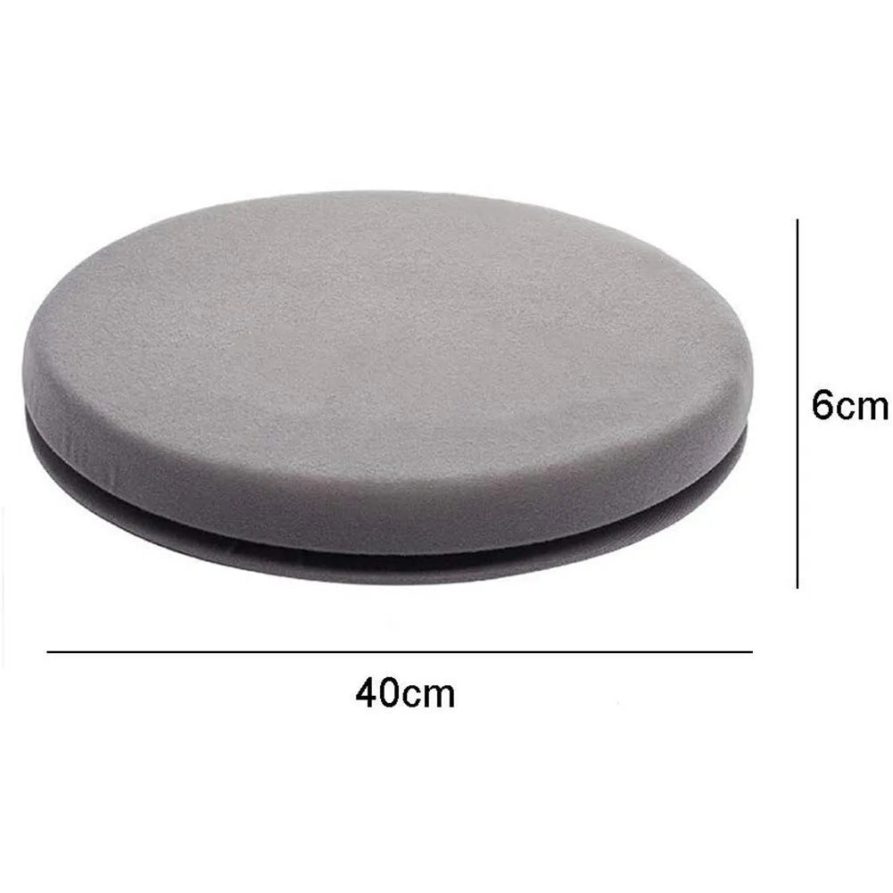 A grey rotating car seat cushion for lumbar support on a car seat.