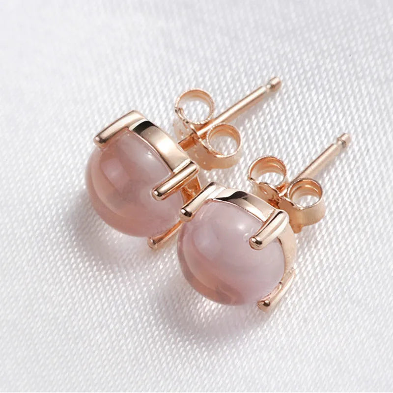 Rose gold drop shape stud earrings with crystal inlay detail on a silver base.