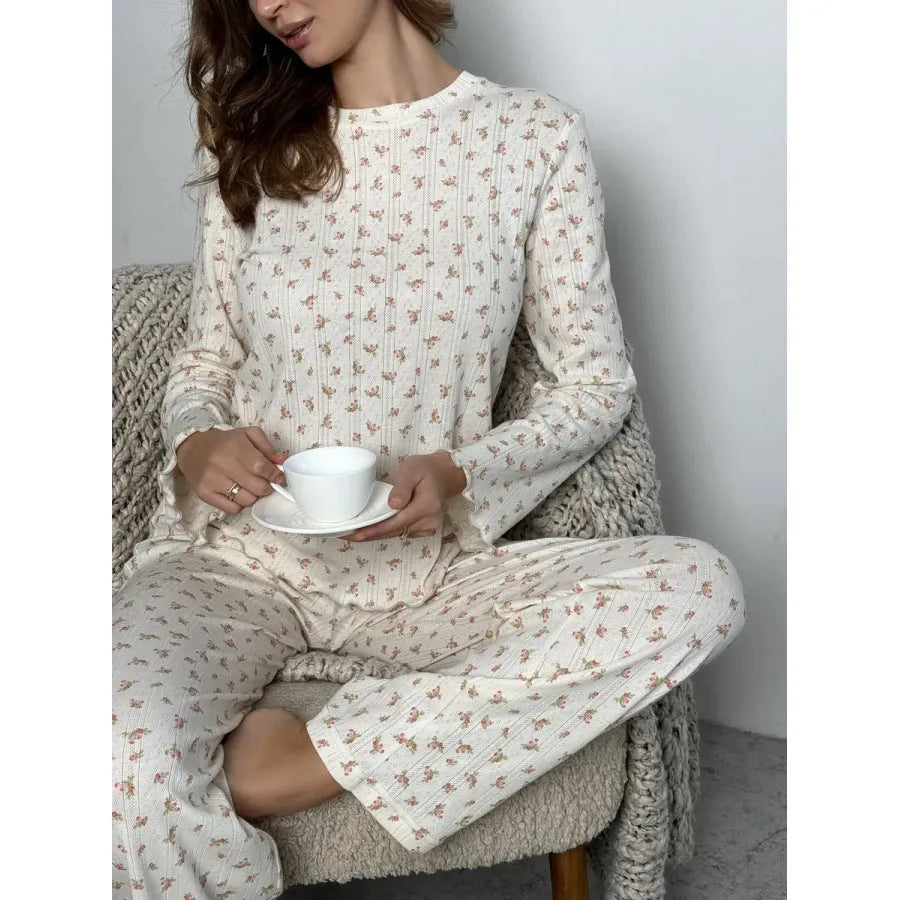 Women's white floral print bell sleeve top and wide-leg trousers loungewear set on a hanger.
