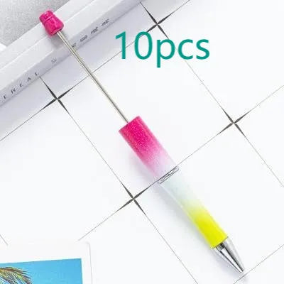 Colourful spinning ballpoint pen with plastic beads on a white background.