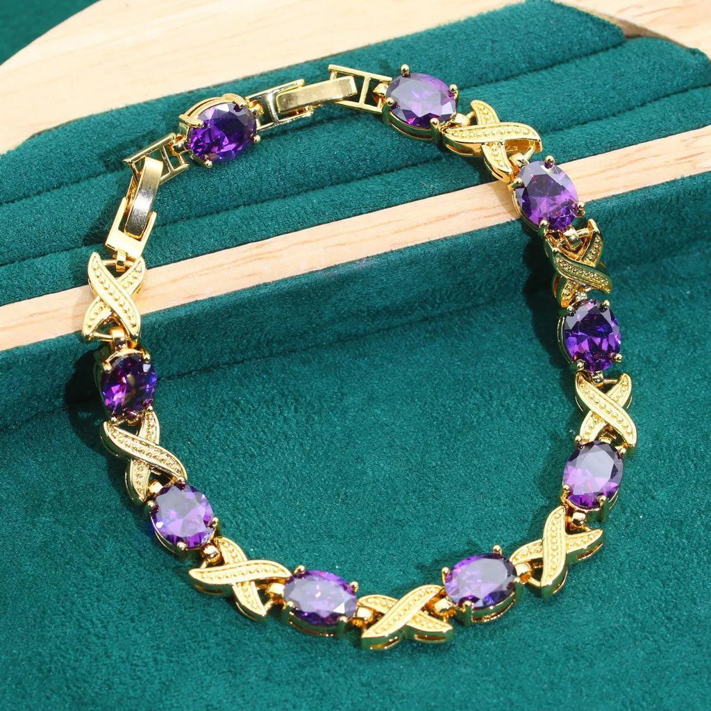 18k gold-plated necklace, bracelet, earrings, and ring set with blue cubic zirconia stones.