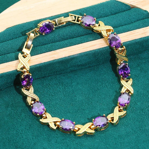 18k gold-plated necklace, bracelet, earrings, and ring set with blue cubic zirconia stones.