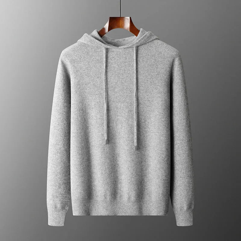 Men's dark grey cashmere hoodie and matching trousers laid out as a complete casual set.