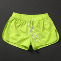 Men's loose beach trousers in polyester with micro elasticity available in black, fluorescent green, and orange red colours