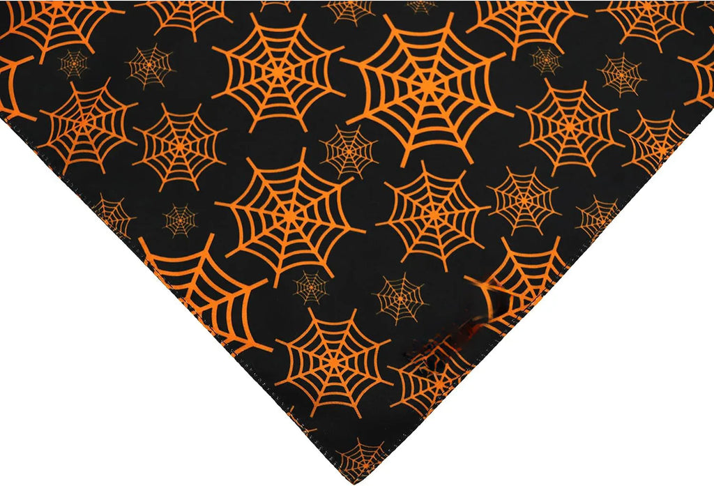 Halloween reversible dog bandana showing pumpkin and spider web patterns in black and orange colours