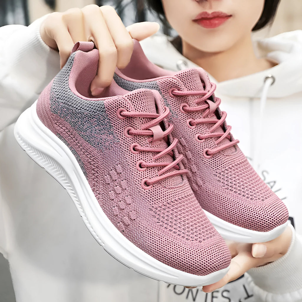 Women's low-top black mesh sneakers with lace-up front and round toe on a soft PVC sole.