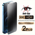 Anti-peeping tempered glass screen protector for iPhone on a table next to a mobile phone.