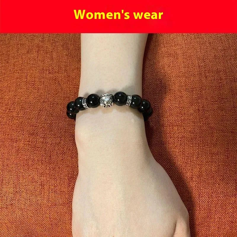 Obsidian unisex bracelet with silver detail in 10mm and 12mm bead size options on a wrist.