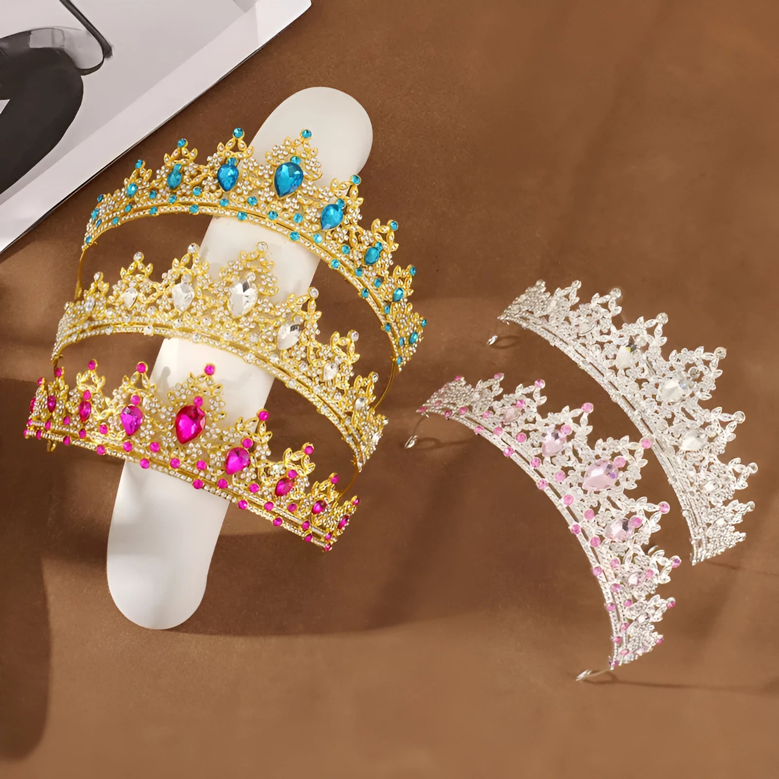 Gold alloy crown-shaped wedding hair headdress with electroplated finish on neutral background