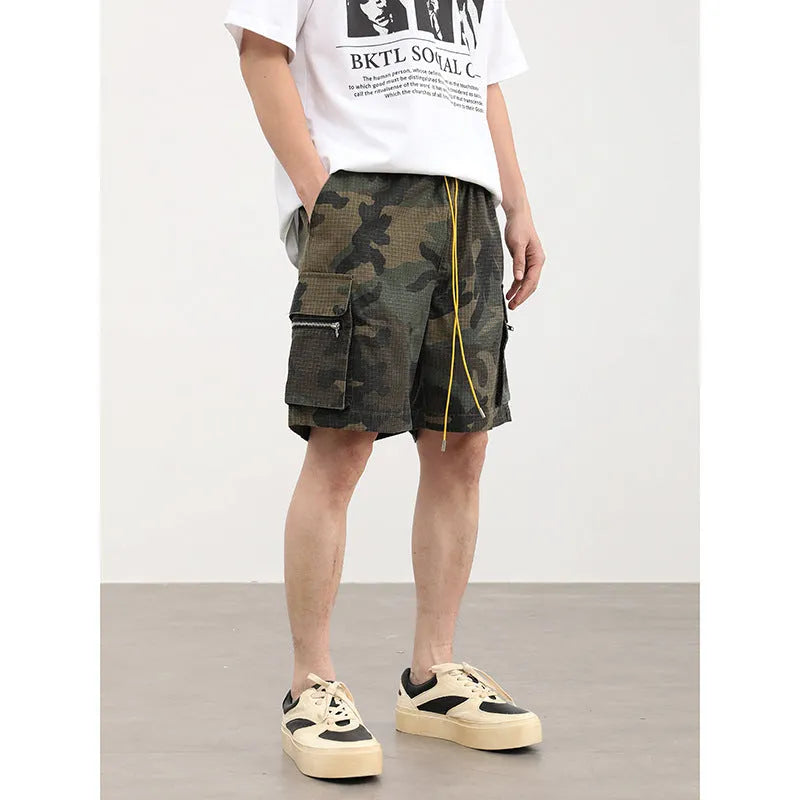 Men's camouflage pattern work shorts with multiple pockets, cropped length, and mid waist design