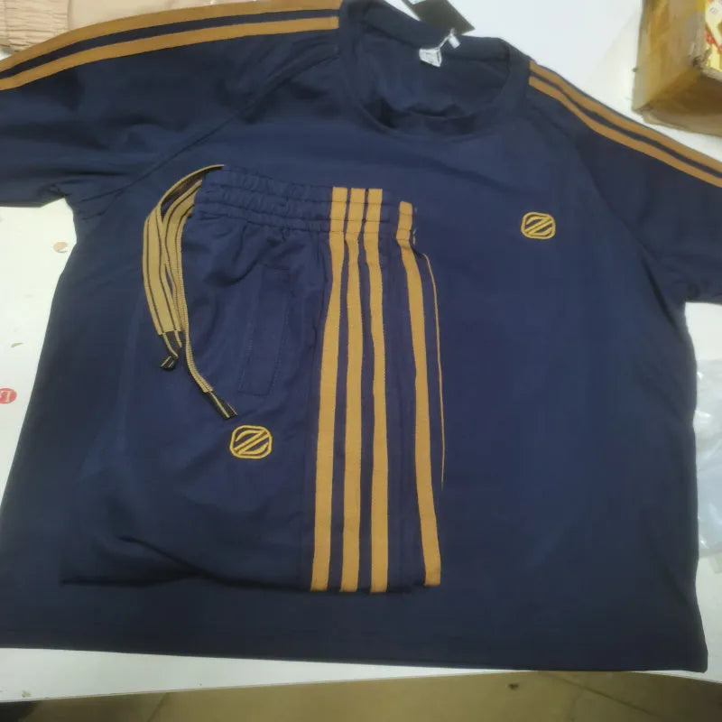 Men's blue polyester sports suit set with short sleeves showing top and pants