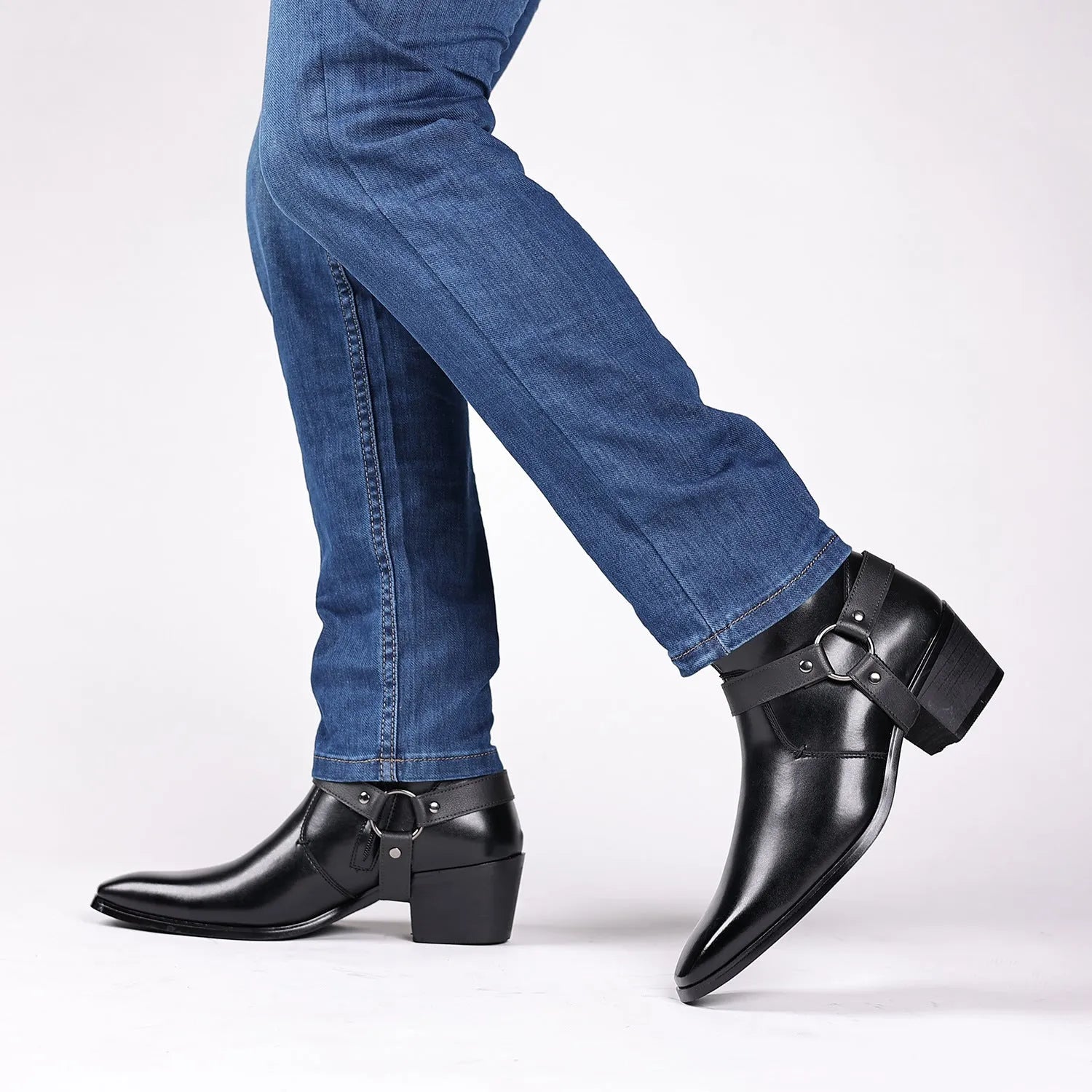 Black unisex ankle boots with side zipper, rivet details, and a high horseshoe heel on a grey background.