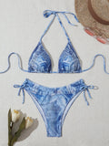 Women's denim blue printed bikini set with strap design on a hanger.