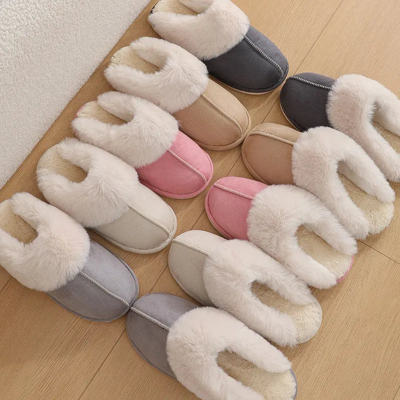 Brown plush indoor slippers for women with a non-slip PVC sole on a wooden floor.