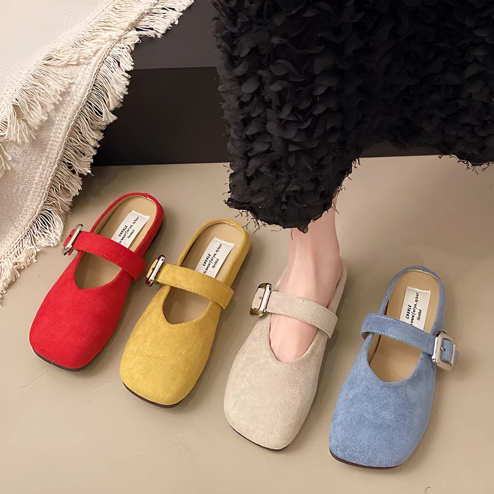Women's flat apricot coloured slippers with a square toe, PU leather upper, and a dark rubber sole.