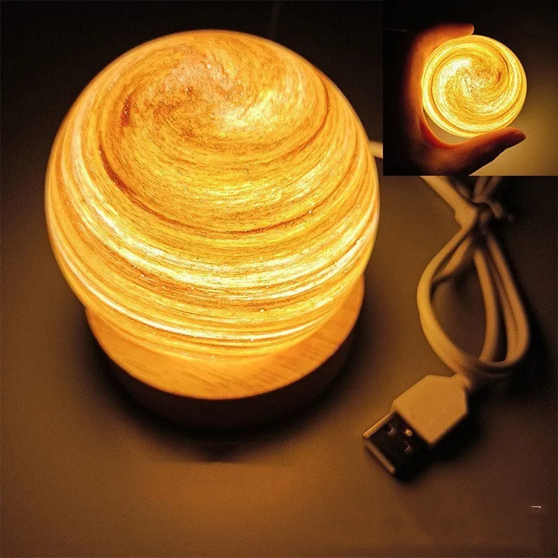 Modern planet-shaped USB night light on its base with dimmable multi-colour glow