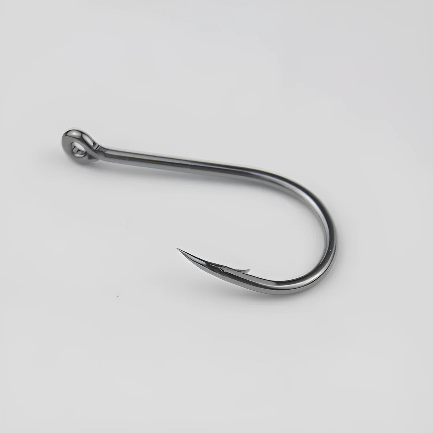 Bulk pack of alloy carbon steel barbed fishing hooks with a hole ring, suitable for rock and sea fishing.