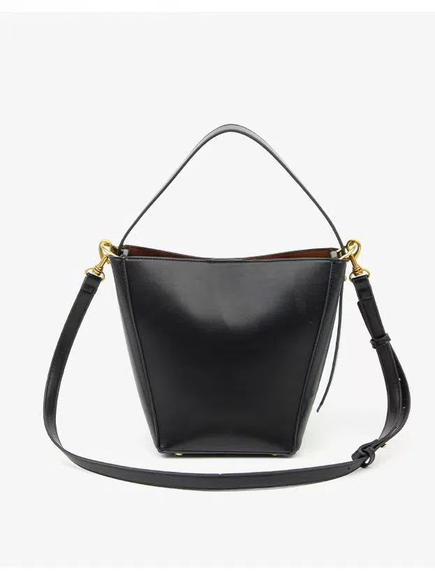 Urban minimalist bucket-style crossbody shoulder bag in PU with three-dimensional outer pocket, black colour option, flat lay view