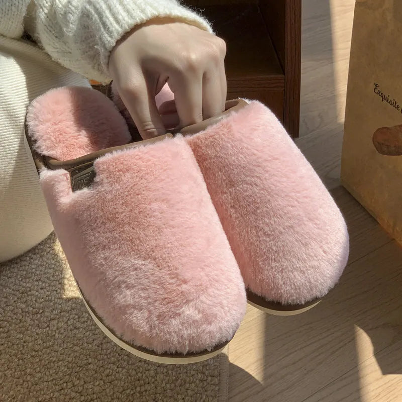 Pair of solid-colour plush PVC slippers with an overshoe design and a textured non-slip sole.