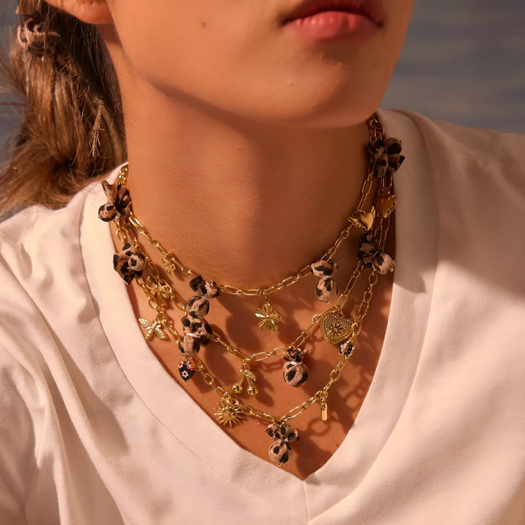 Stainless steel necklace with a geometric leopard and love heart flower pendant on an adjustable chain.