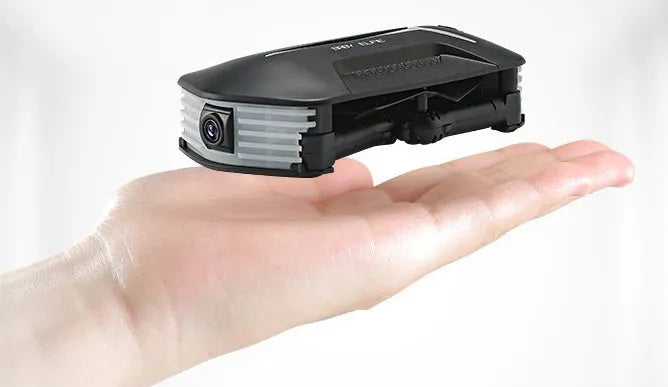 Black gravity-sensing four-axis folding drone with HD camera on a white background