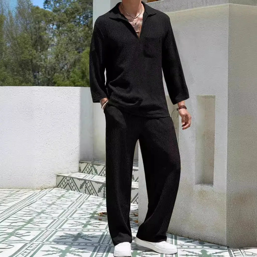 Man wearing a casual lake blue polyester shirt and matching trousers from a two-piece suit set.