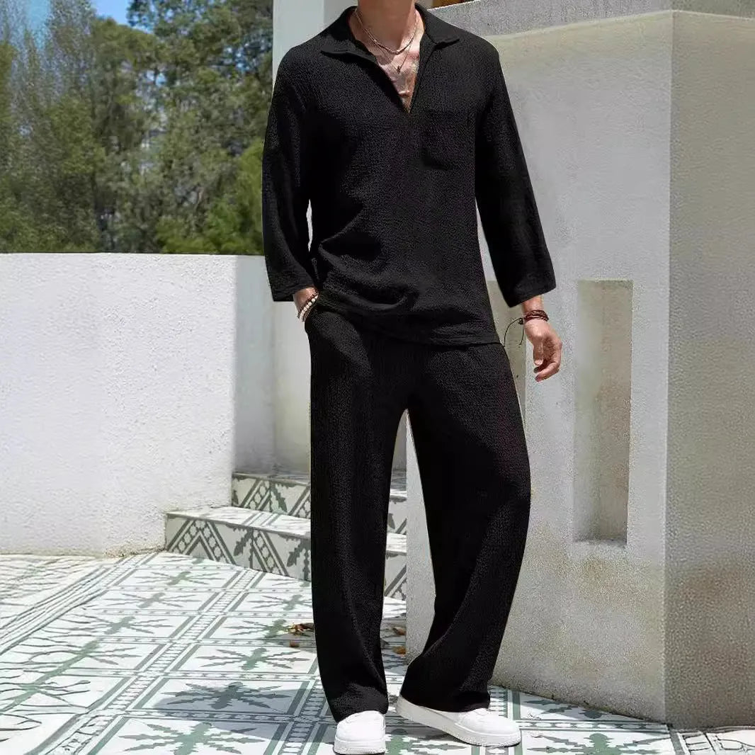 Man wearing a casual lake blue polyester shirt and matching trousers from a two-piece suit set.
