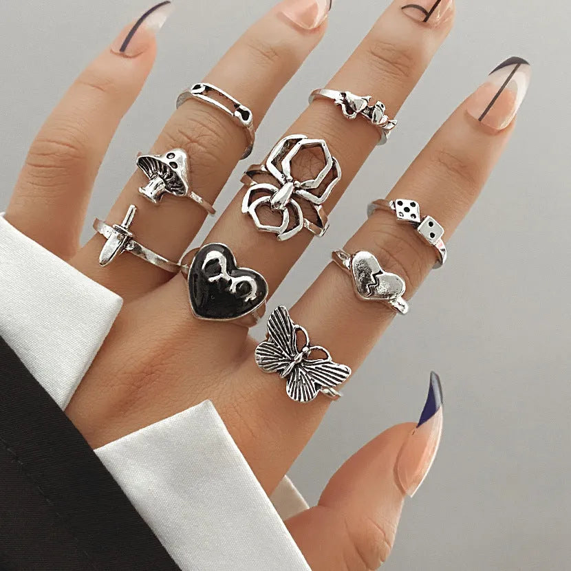 Alloy ring set with butterfly and snake retro geometric designs on display