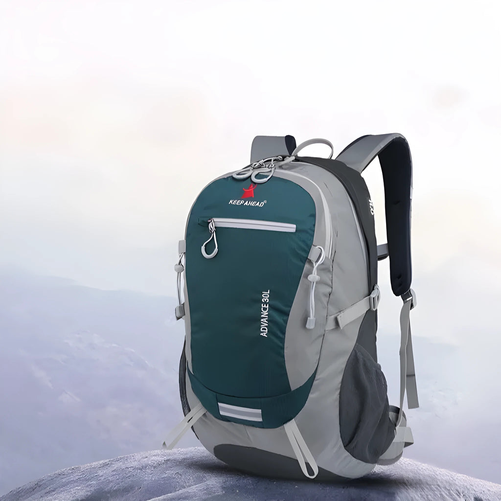 Nylon 30-litre waterproof backpack in dark green with airpillow straps, shown in an outdoor setting.