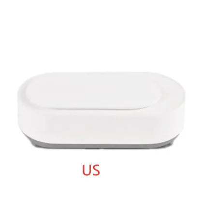 White portable ultrasonic cleaner with stainless steel tank and a single control button.