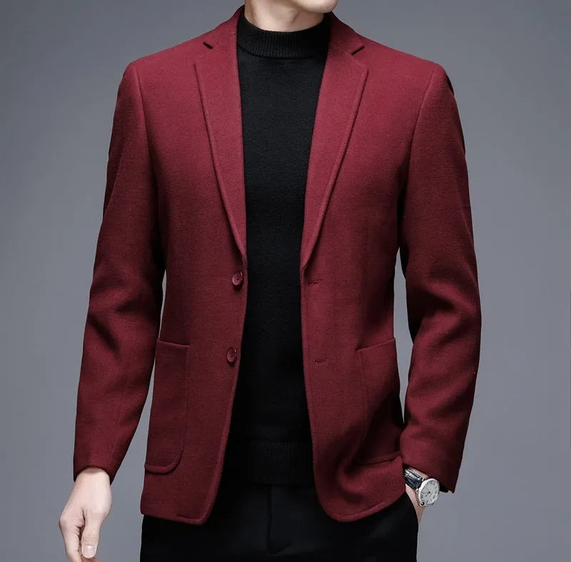 A man wearing a solid-colour loose-fit casual wool-style jacket with a round hem and long sleeves.