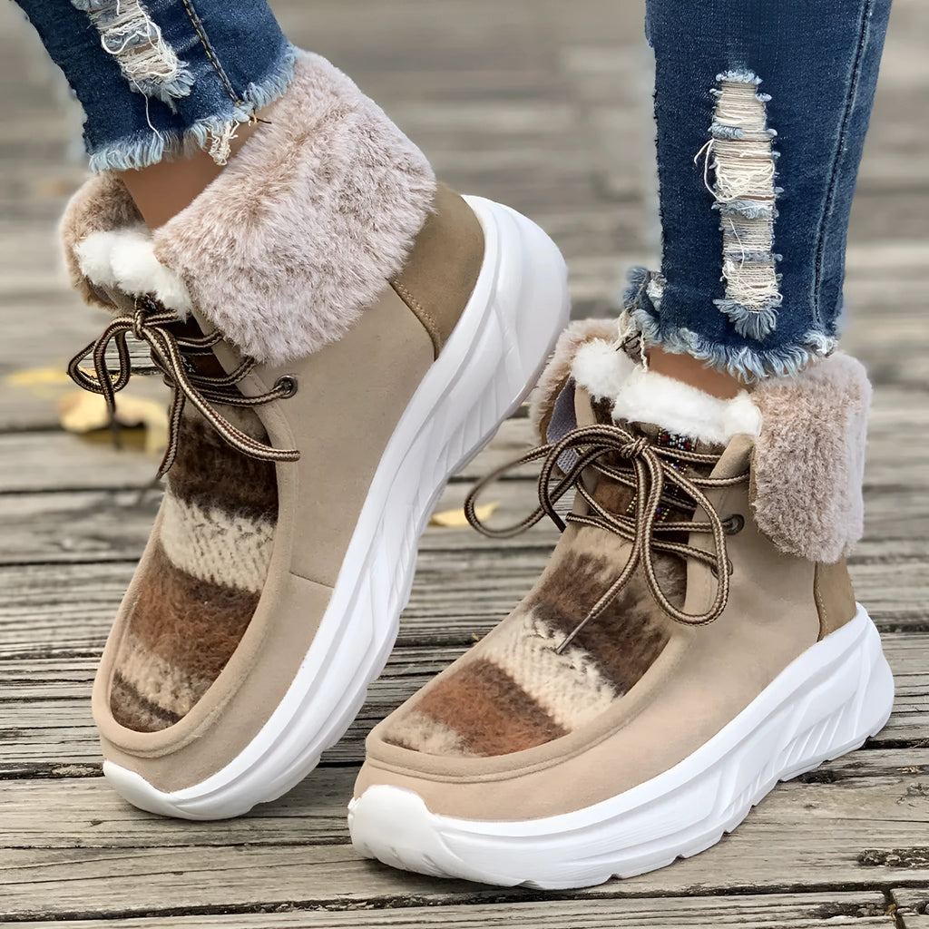 Beige women's mid-top suede snow boots with lace-up front and a thick rubber sole.