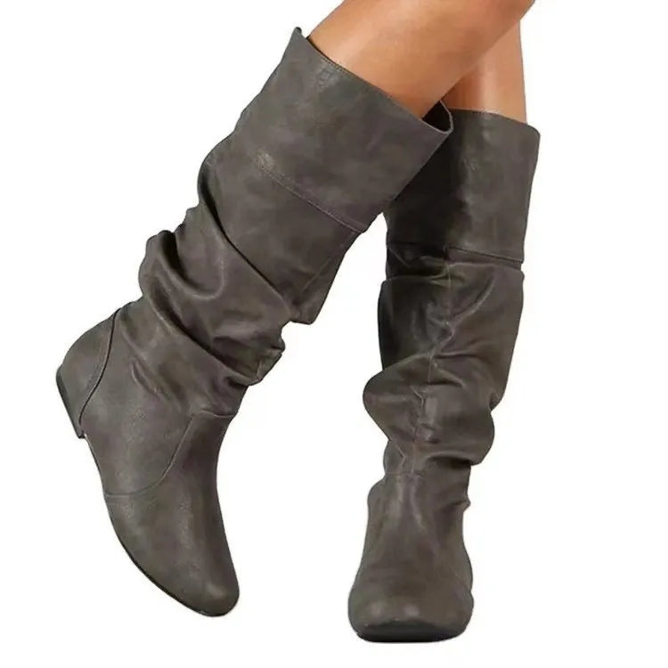 Women's flat slip-on long boots in black with round toe and high cylinder shaft, on a rubber sole.