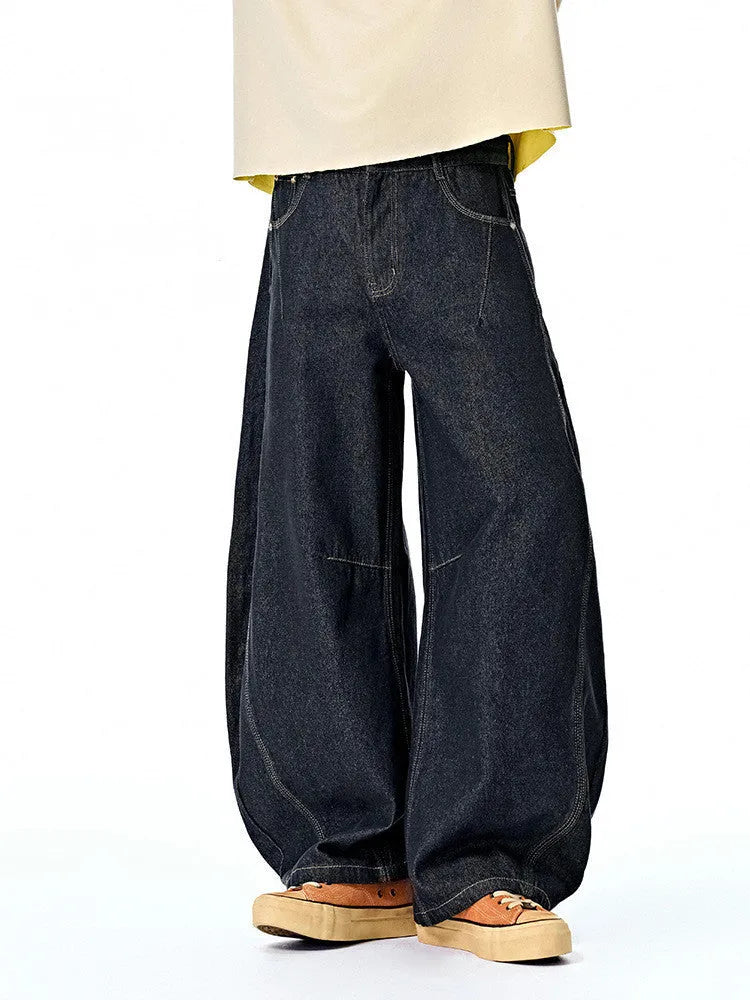 Men's original cow colour wide leg denim trousers laid flat.