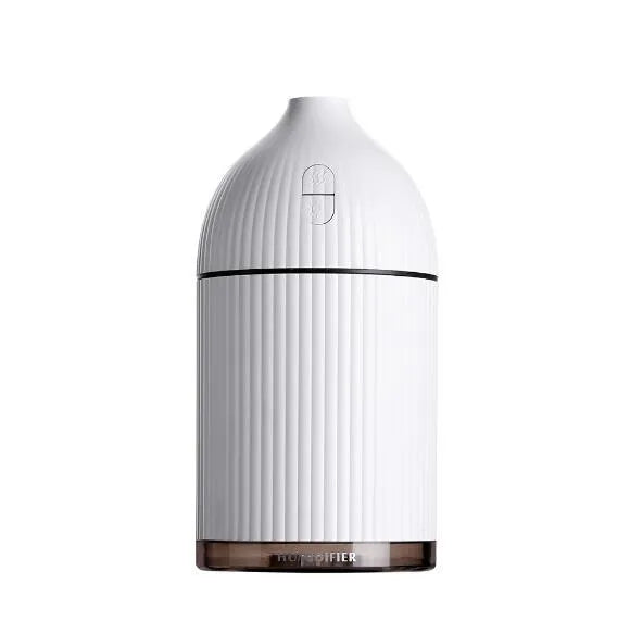 White USB aromatherapy diffuser and humidifier with LED light on a wooden desk