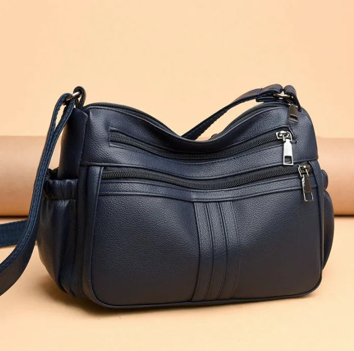 Genuine leather cross-body messenger bag in horizontal square shape with internal organisers