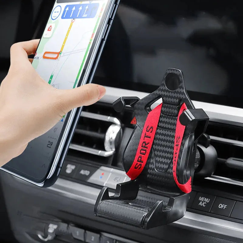 Gold car air vent phone holder with racing seat shape mounted on a car vent, showing 360-degree rotation.