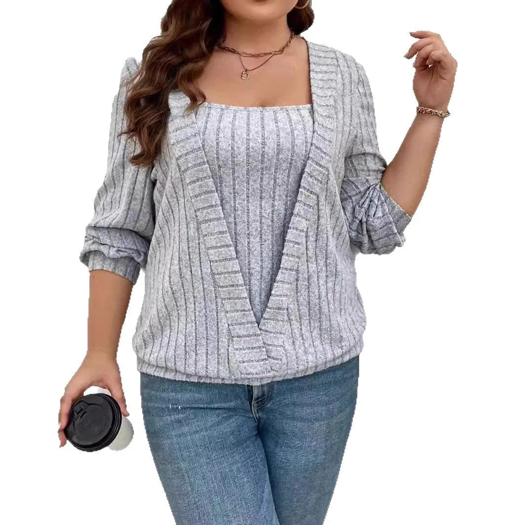 Solid colour rib fabric V-neck long sleeve top with a false two-piece suit design on a hanger.
